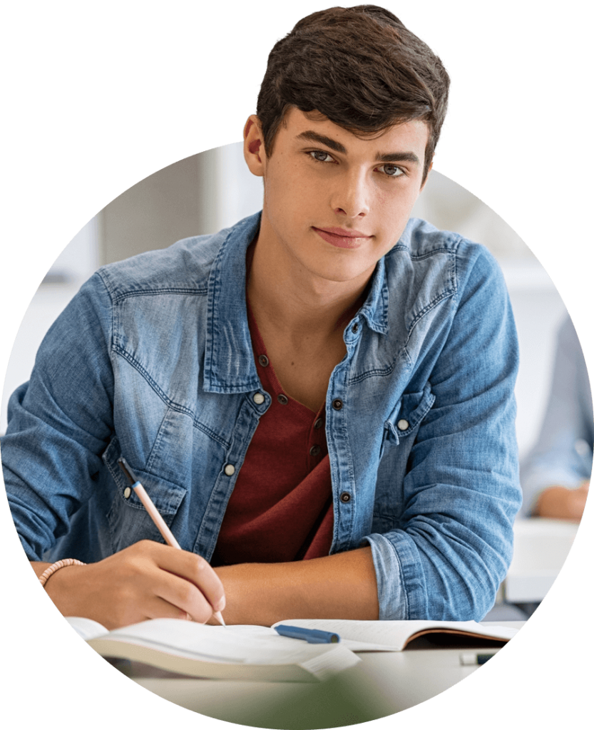 Male student taking notes during lecture